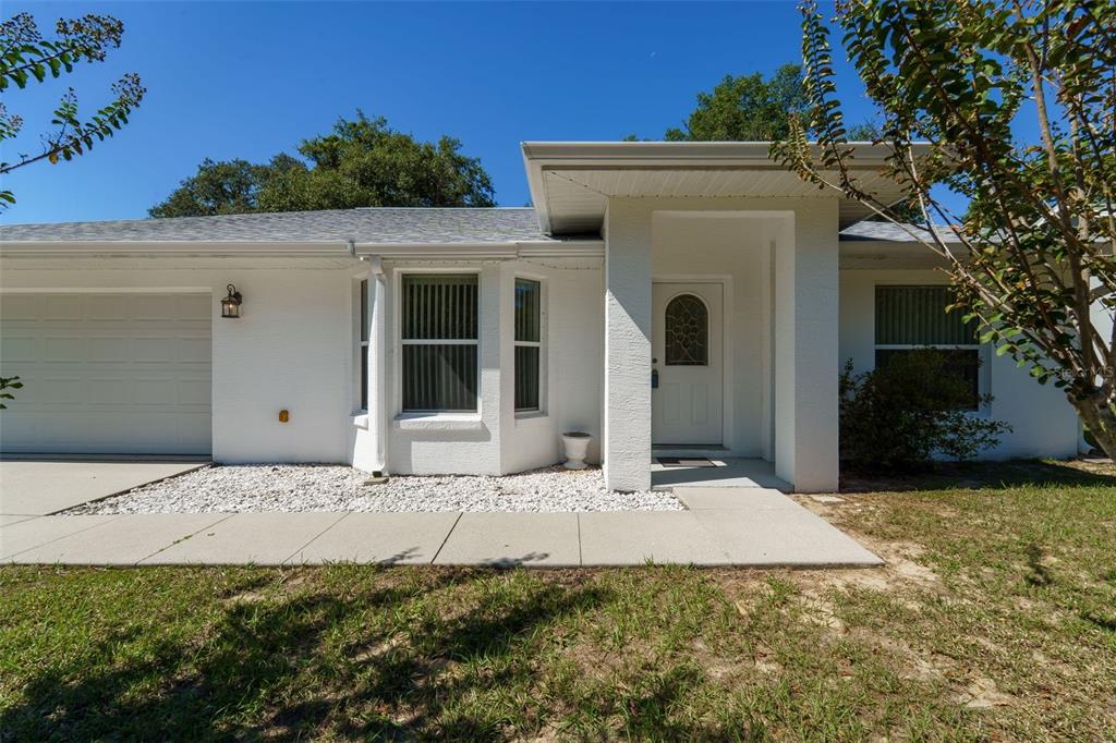 729 Longfellow Terrace Inverness, FL 34450 - Photo 2 of 37 a front view of a house with a yard