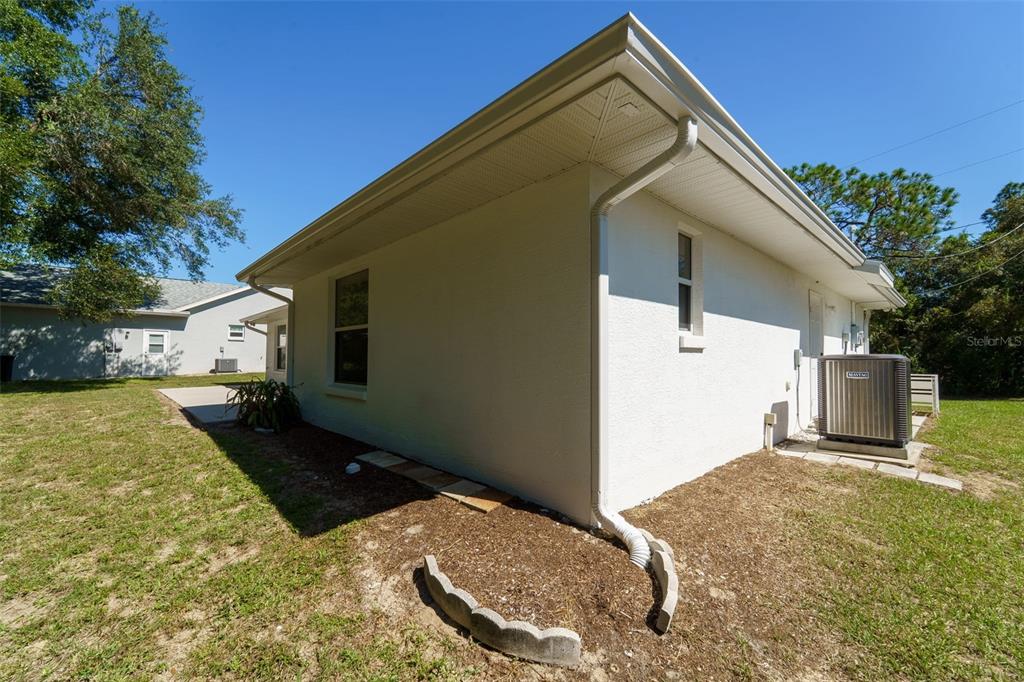 729 Longfellow Terrace Inverness, FL 34450 - Photo 23 of 37 a backyard of a house with dishwasher and a yard