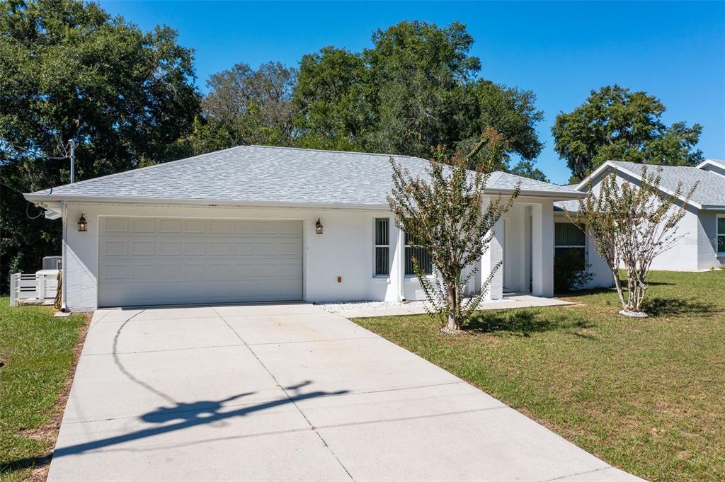 729 Longfellow Terrace Inverness, FL 34450 - Photo 37 of 37 a view of a house with a yard and large tree