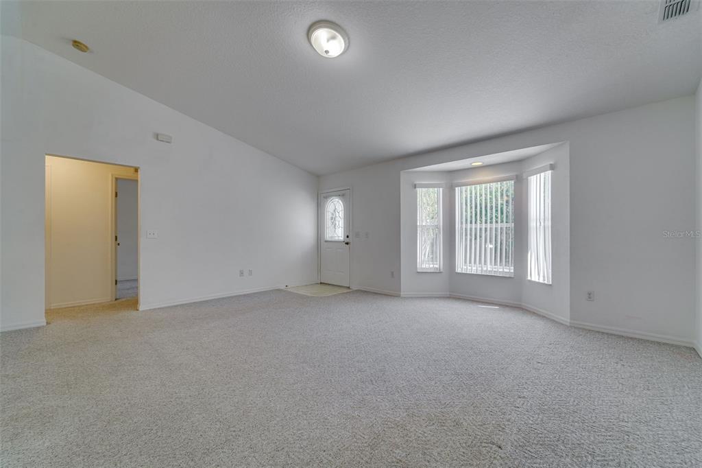 729 Longfellow Terrace Inverness, FL 34450 - Photo 6 of 37 an empty room with windows and closet