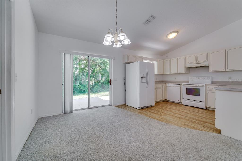 729 Longfellow Terrace Inverness, FL 34450 - Photo 8 of 37 a view of a kitchen with a stove cabinets and a chandelier