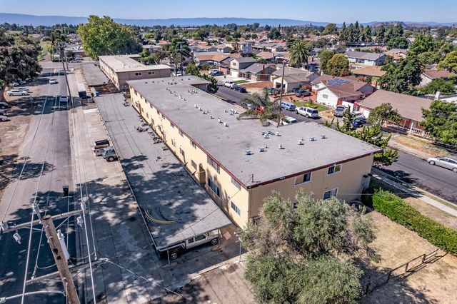 an aerial view of a house with large trees