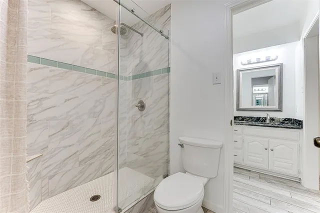 a bathroom with a toilet a sink and shower