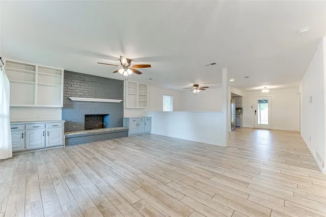 a view of a room wooden floor and fireplace