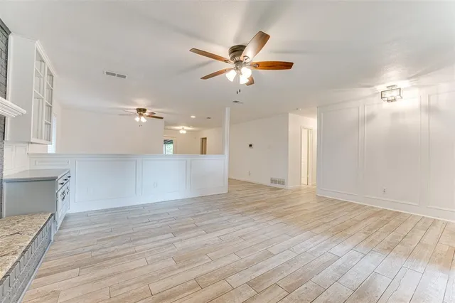 a view of a kitchen with a dishwasher cabinets and wooden floor