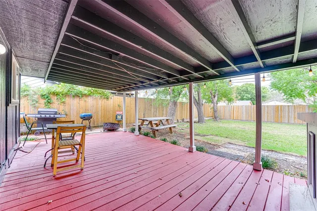 a patio with wooden floors and outdoor seating