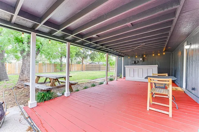 a patio with glass top table and chairs