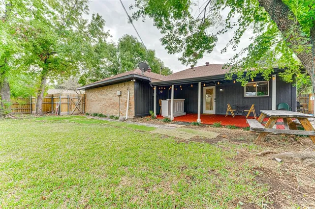 a view of a house with backyard porch and sitting area