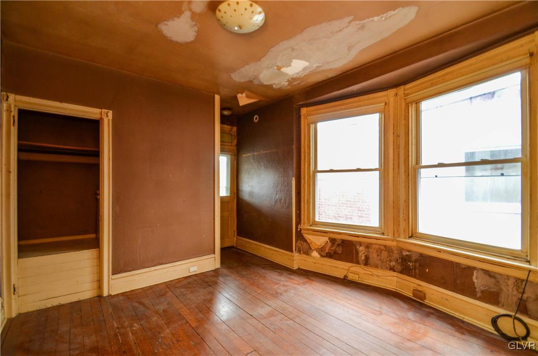 1650 Mineral Spring Road Reading, PA 19602 - Photo 12 of 26 an empty room with wooden floor and windows