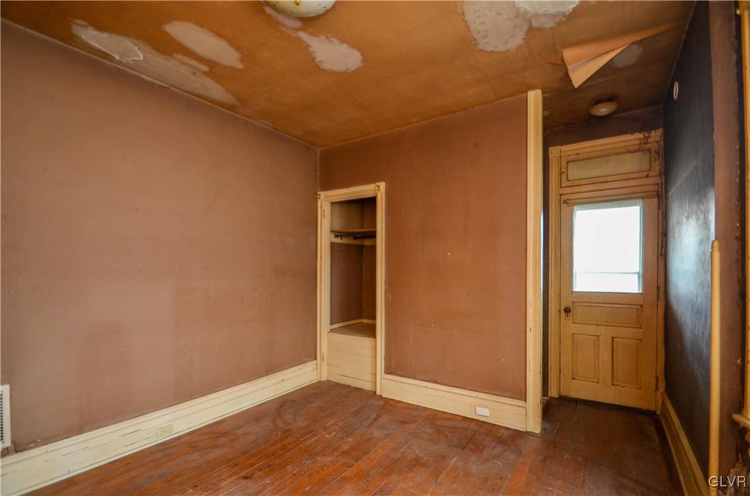 1650 Mineral Spring Road Reading, PA 19602 - Photo 13 of 26 an empty room with wooden floor and windows