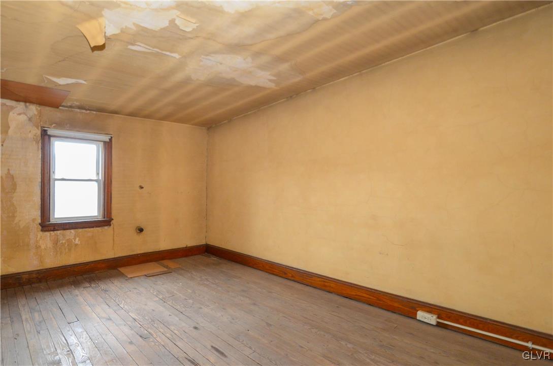 1650 Mineral Spring Road Reading, PA 19602 - Photo 23 of 26 an empty room with wooden floor and windows