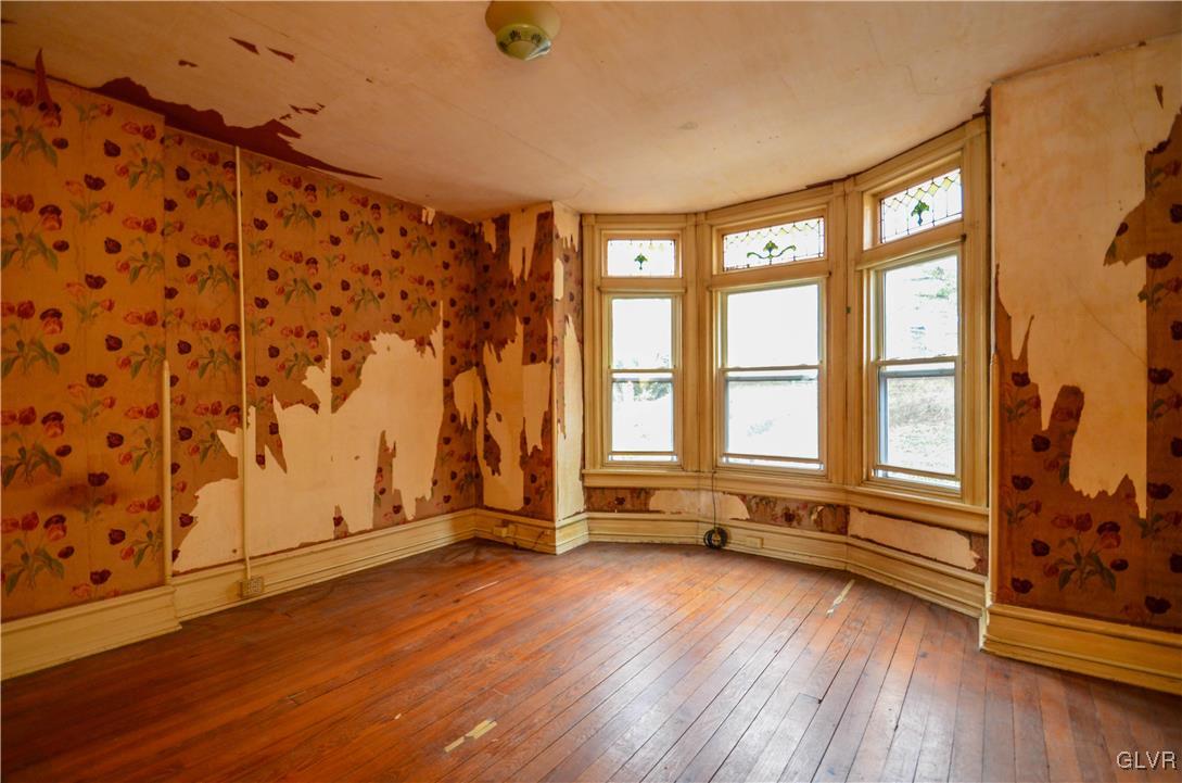 1650 Mineral Spring Road Reading, PA 19602 - Photo 7 of 26 an empty room with wooden floor and windows