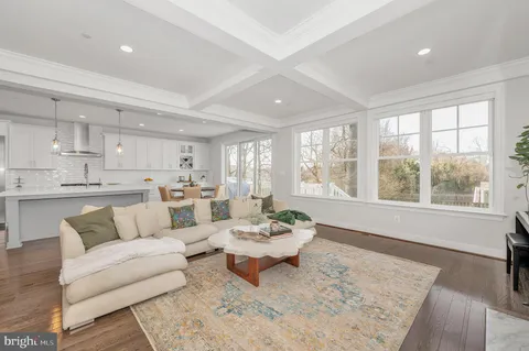 a view of a dining room with furniture a chandelier and wooden floor