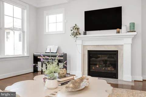 a large kitchen with stainless steel appliances granite countertop lots of counter top space and wooden floor