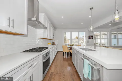 a stove top oven sitting inside of a kitchen