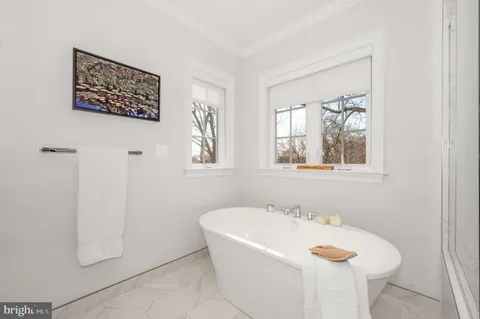 a bedroom with a bed and painting on the wall