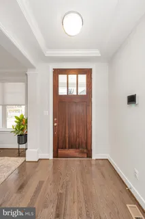 a very nice looking dining room with furniture window and wooden floor