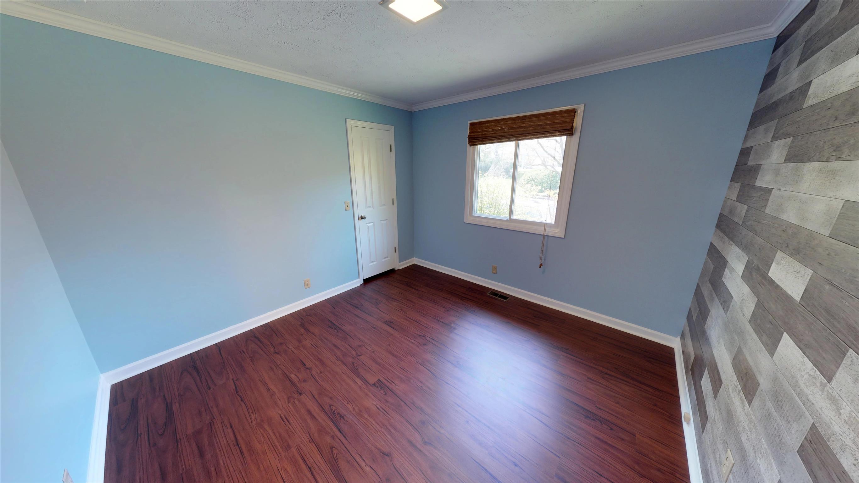111 Spring Valley Road Nashville, TN 37214 - Photo 17 of 29 a view of an empty room with wooden floor and a window