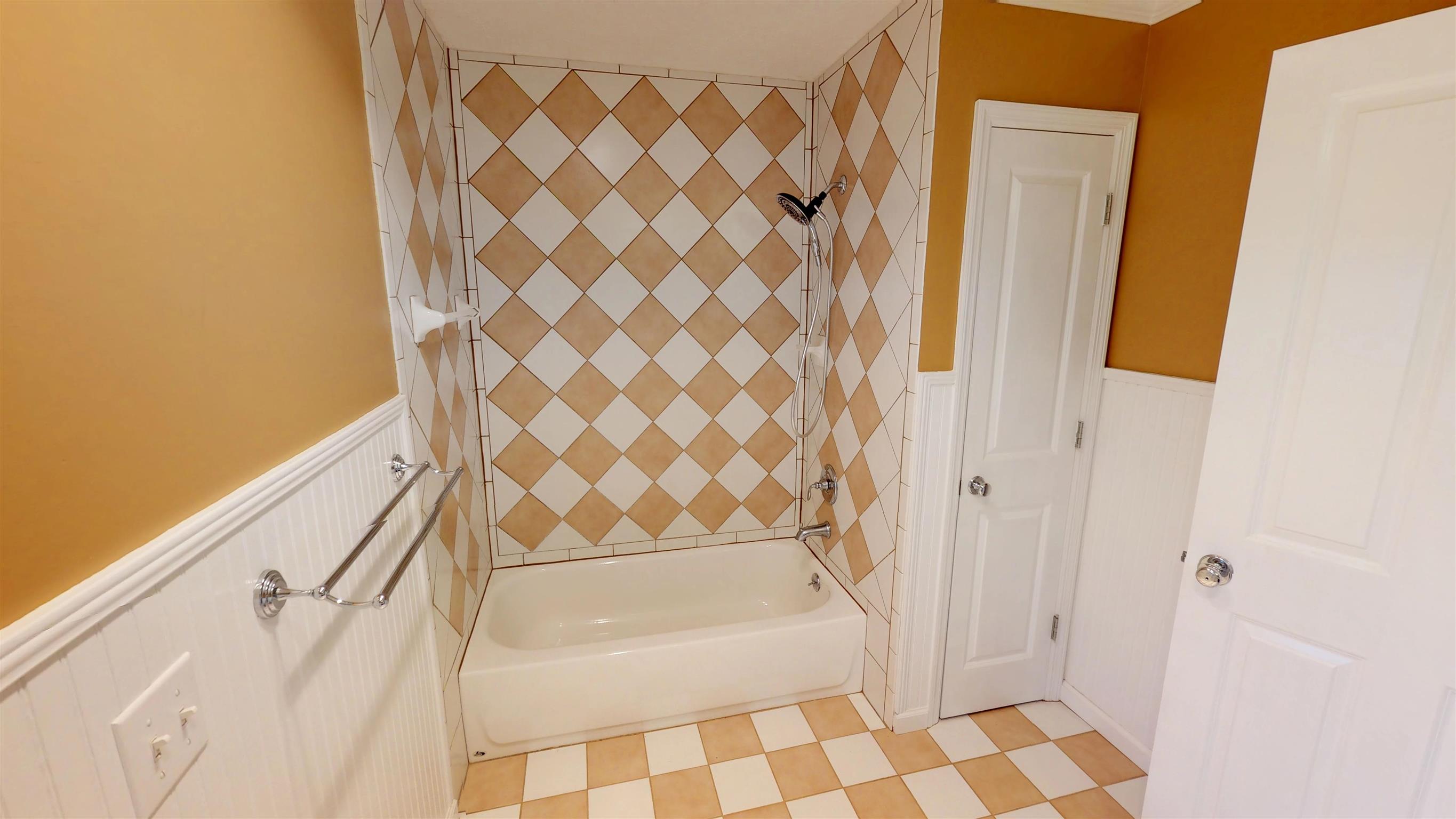 111 Spring Valley Road Nashville, TN 37214 - Photo 19 of 29 a bathroom with a bathtub and a shower