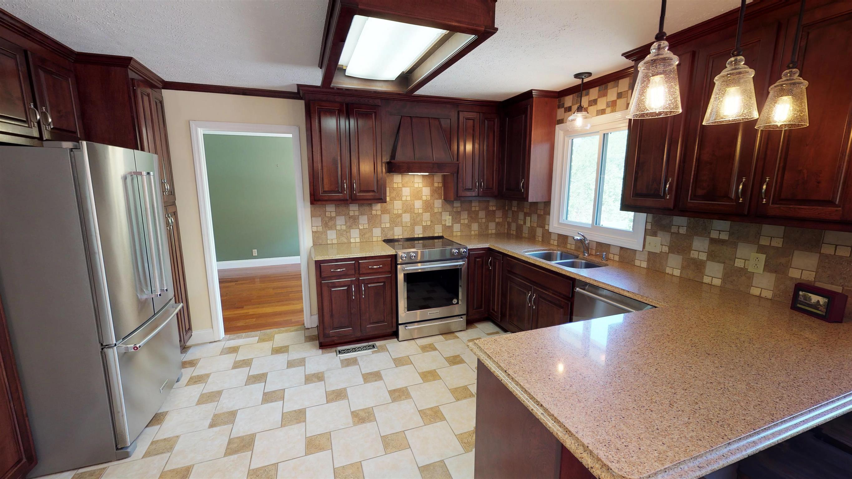 111 Spring Valley Road Nashville, TN 37214 - Photo 7 of 29 a kitchen with stainless steel appliances granite countertop a sink stove and refrigerator