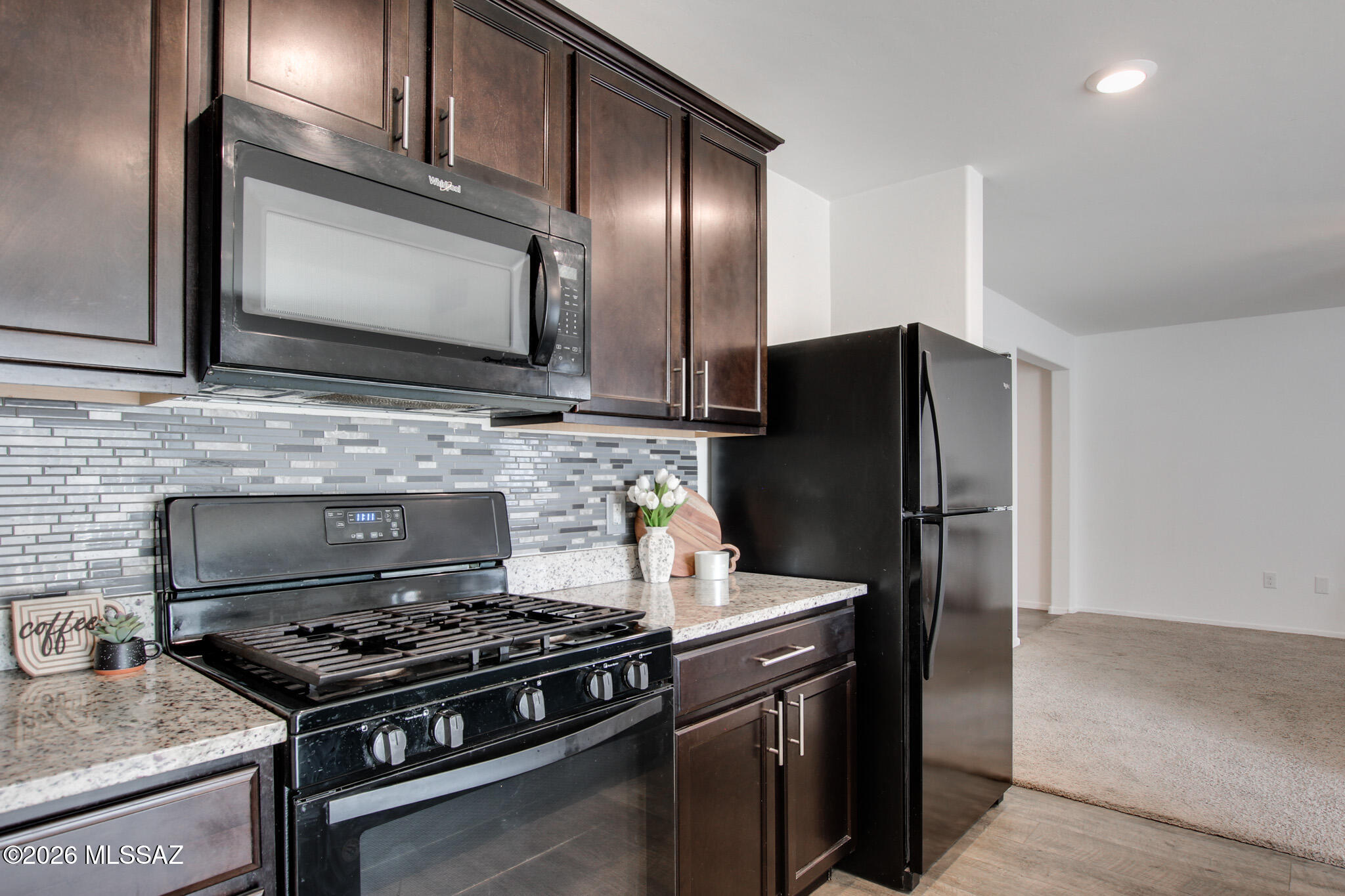 5987 South Antrim Loop Tucson, AZ 85706 - Photo 14 of 34 a kitchen with a stove and a microwave