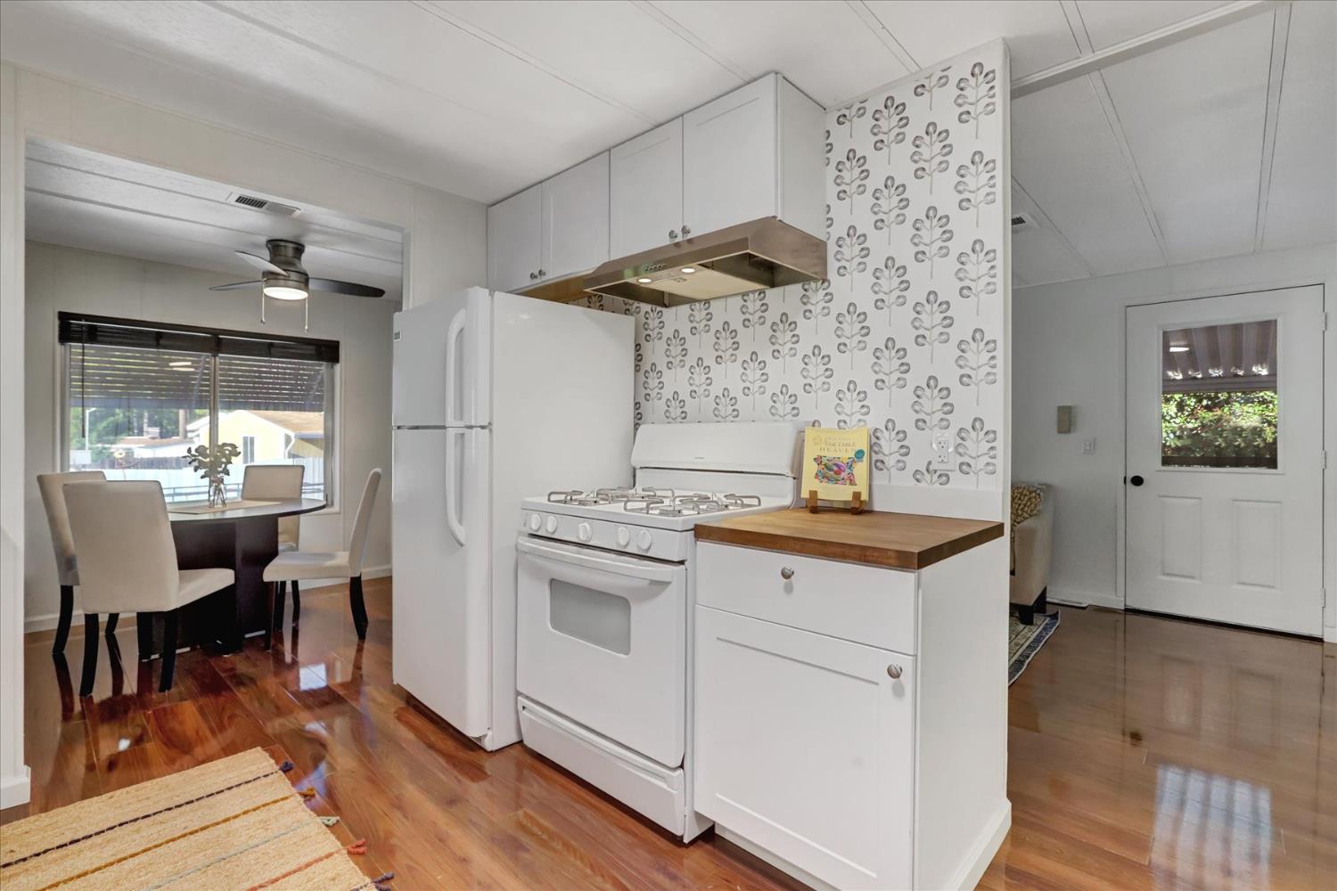 65 Primrose Lane Grass Valley, CA 95945 - Photo 13 of 41 a kitchen with stainless steel appliances a white stove top oven and a wooden floors