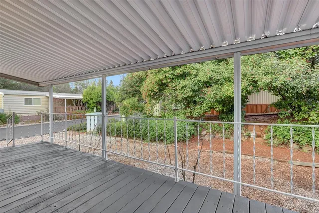 a view of a street with wooden fence