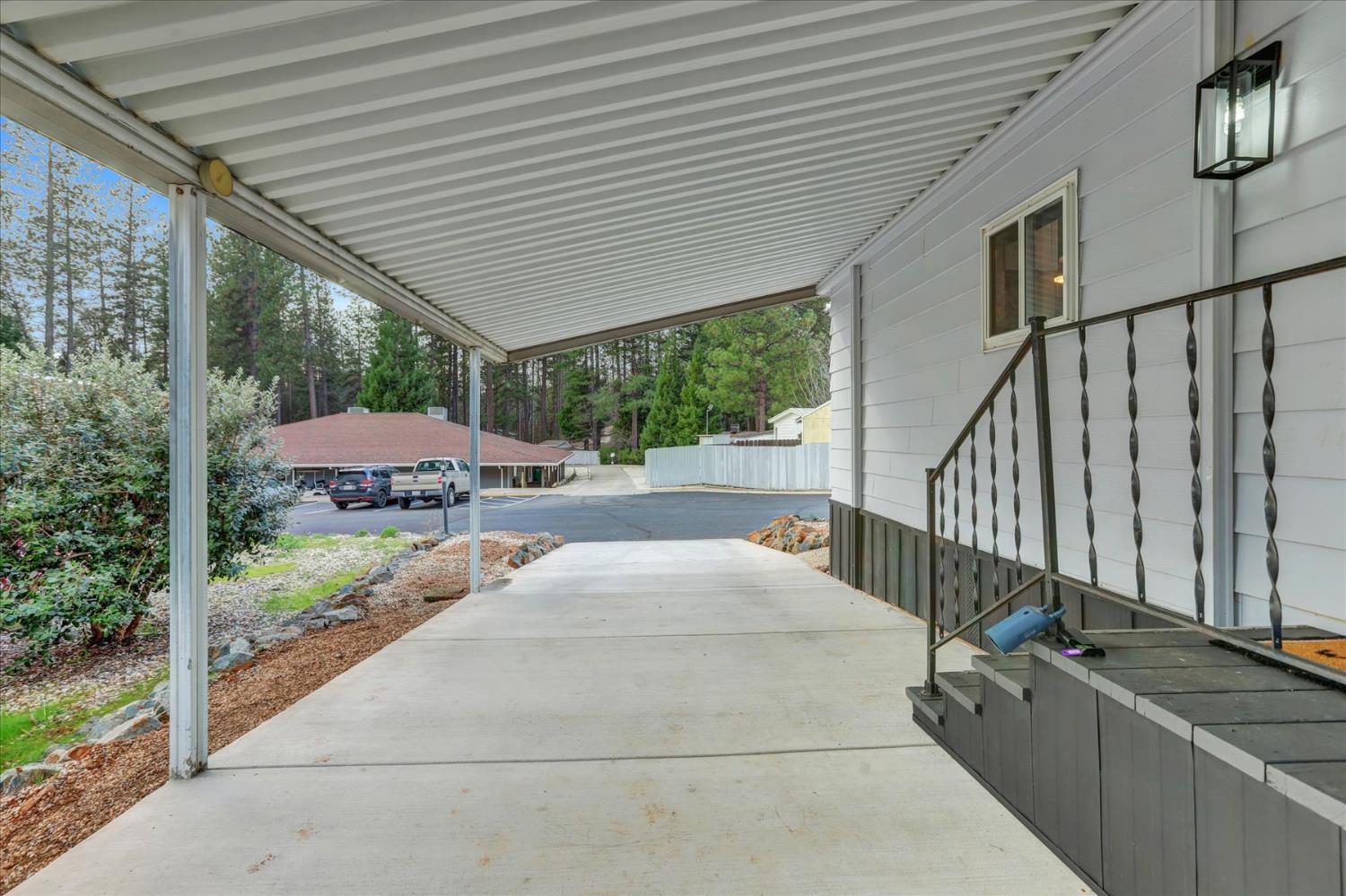 65 Primrose Lane Grass Valley, CA 95945 - Photo 31 of 41 a view of a patio with couches under an umbrella