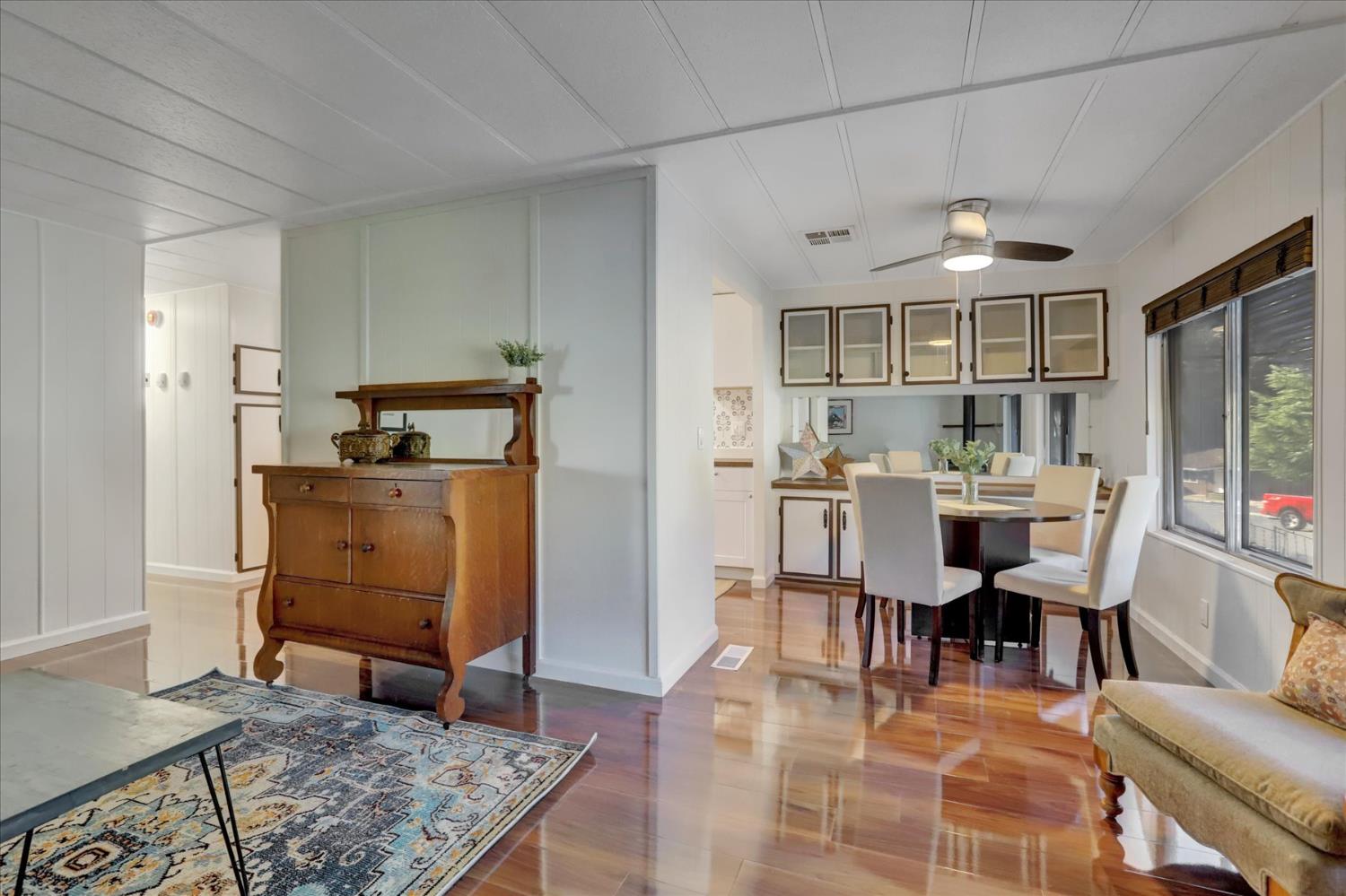 65 Primrose Lane Grass Valley, CA 95945 - Photo 6 of 41 a living room with furniture a rug kitchen view and a chandelier