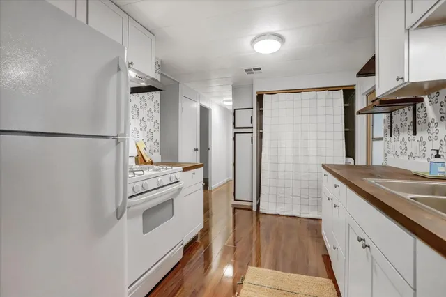 a kitchen with a sink stove and refrigerator