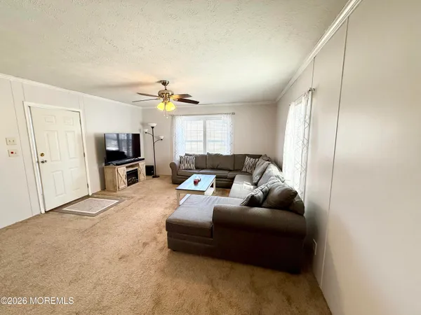 a living room with furniture and kitchen view