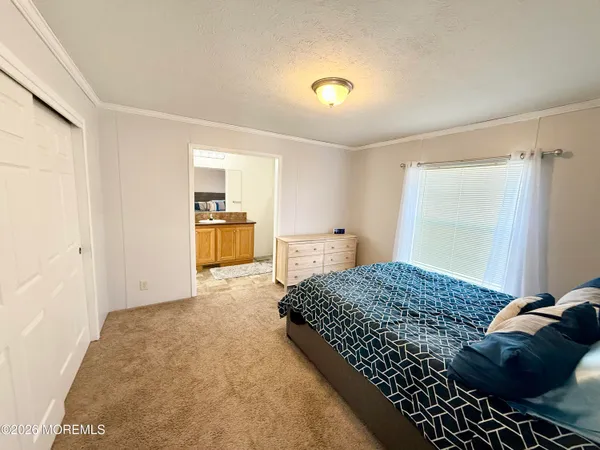 a bedroom with a bed and a walk in closet