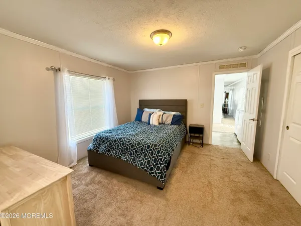 a bedroom with a bed and a table