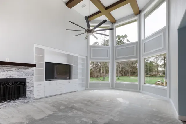 a view of empty room with furniture and fireplace
