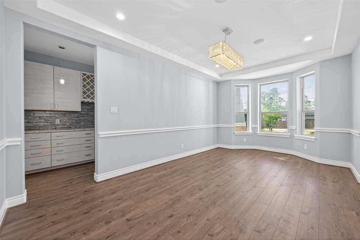 2504 Southline Road Conroe, TX 77384 - Photo 11 of 26 wooden floor in an empty room with a window