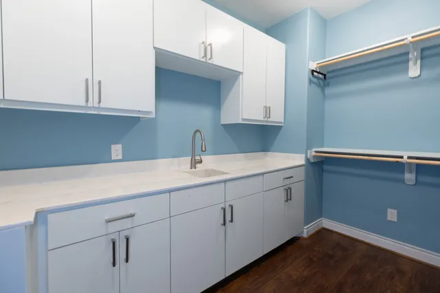 a kitchen with white cabinets and a sink