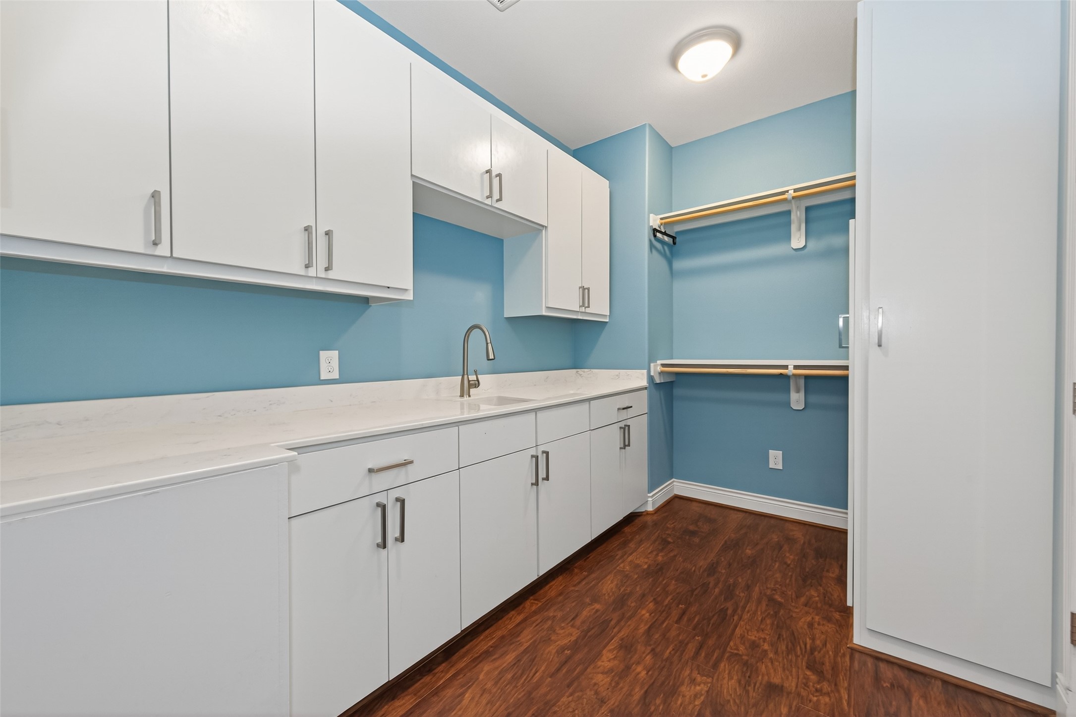 2504 Southline Road Conroe, TX 77384 - Photo 19 of 26 a kitchen with cabinets and wooden floor