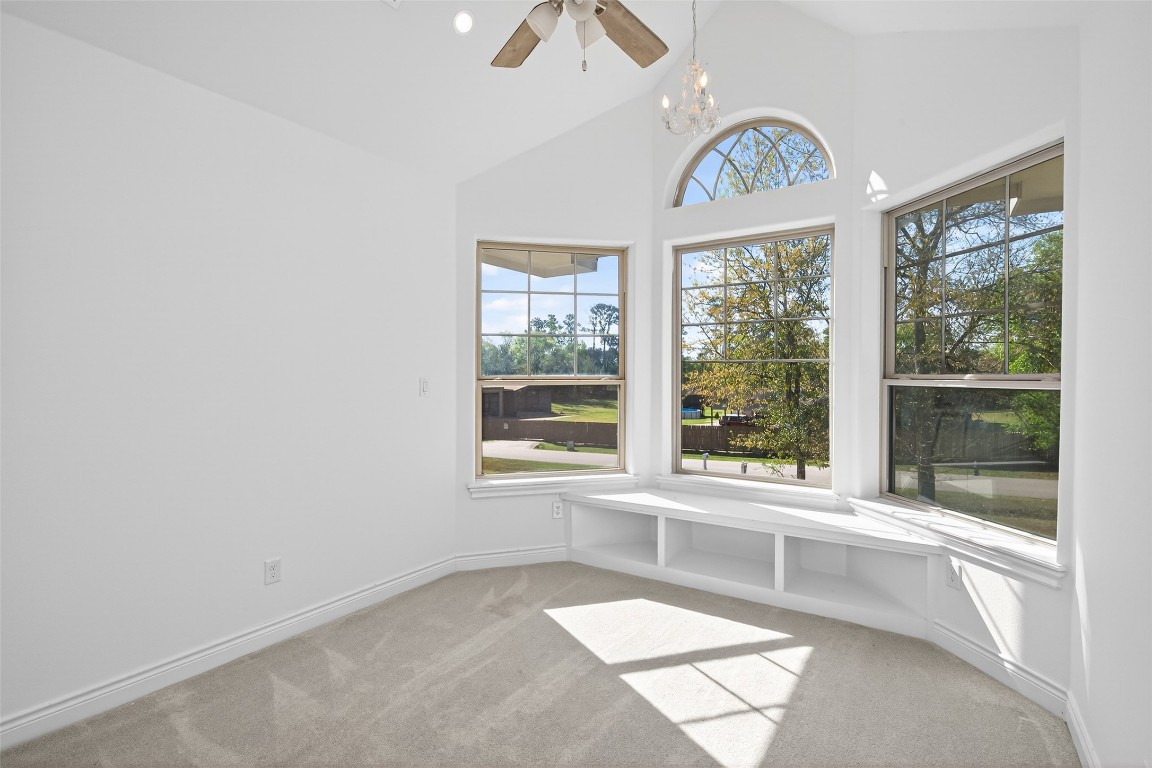 2504 Southline Road Conroe, TX 77384 - Photo 21 of 26 an empty room with windows and chandelier fan