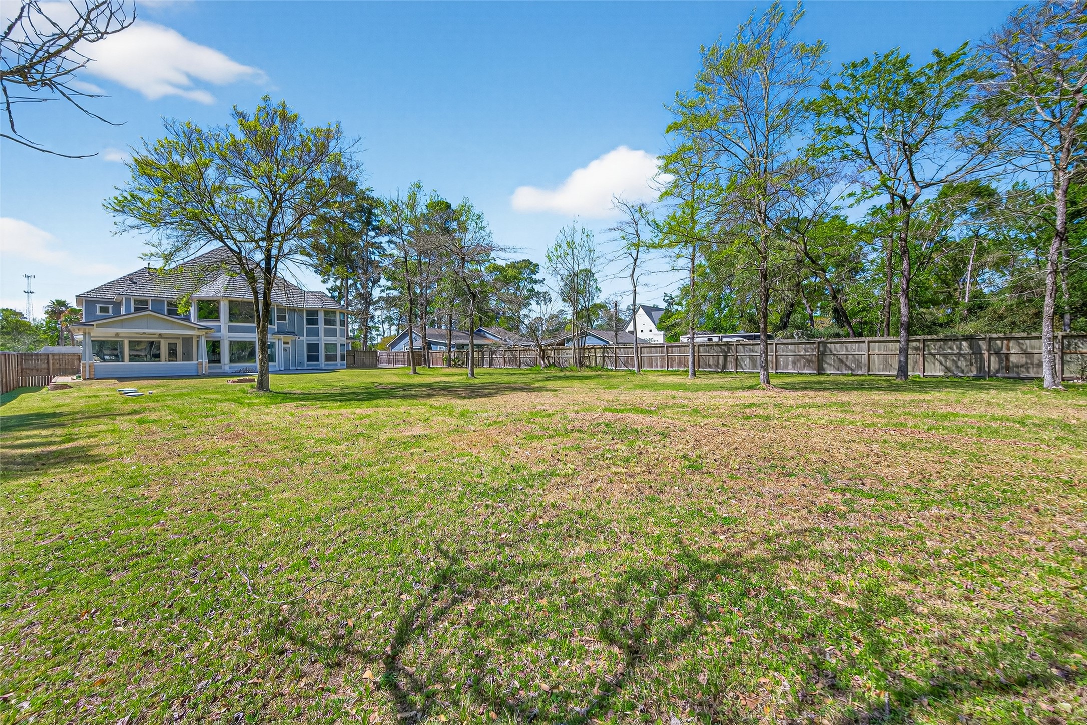 2504 Southline Road Conroe, TX 77384 - Photo 24 of 26 a view of a swimming pool with a yard and trees