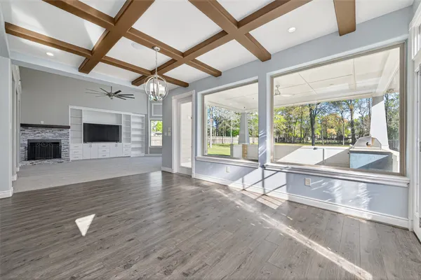 a view of a livingroom with wooden floor and a ceiling fan