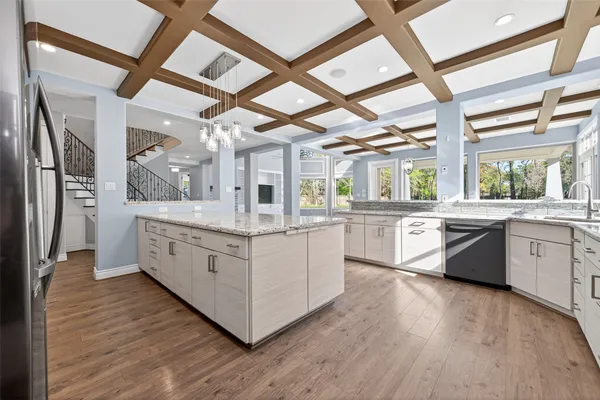 a kitchen with granite countertop white cabinets and white appliances