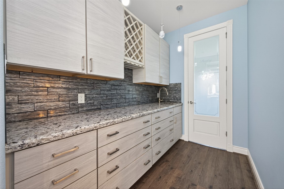 2504 Southline Road Conroe, TX 77384 - Photo 9 of 26 a kitchen with granite countertop white cabinets and white appliances