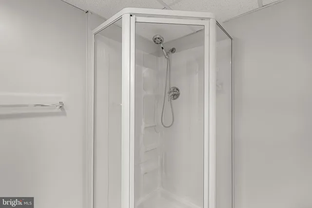 a bathroom with a glass shower door