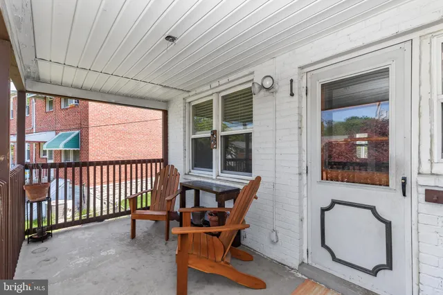 a view of a two chairs in the balcony