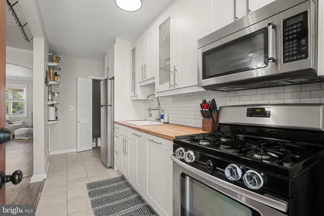 a kitchen with stainless steel appliances granite countertop a stove and a refrigerator