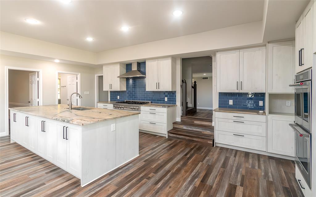 13 Crestview Circle Rockwall, TX 75087 - Photo 12 of 37 a kitchen with stainless steel appliances granite countertop a stove and cabinets