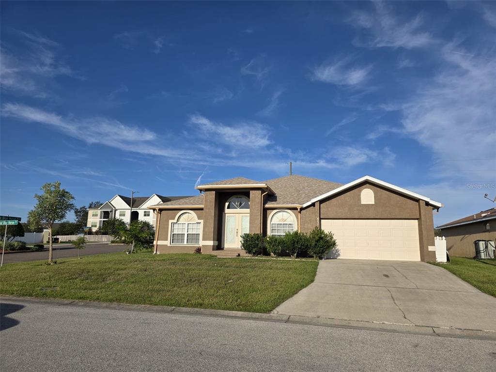 4532 Great Blue Heron Drive Lakeland, FL 33812 - Photo 1 of 33 a front view of a house with a yard and garage
