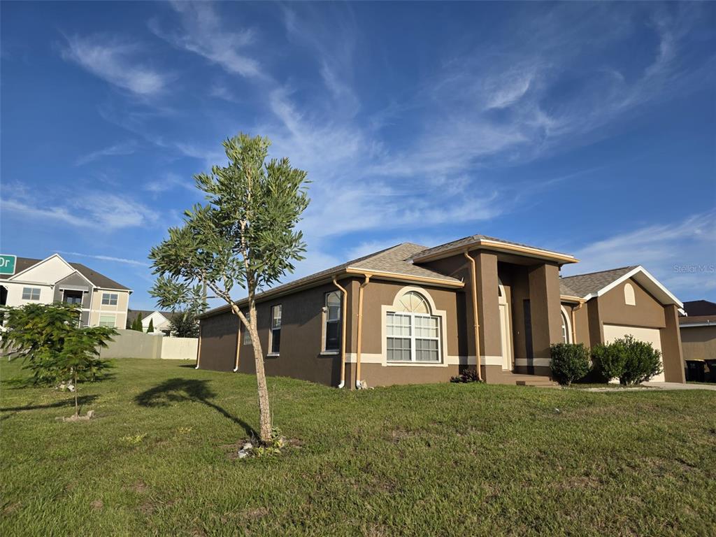 4532 Great Blue Heron Drive Lakeland, FL 33812 - Photo 3 of 33 a front view of a house with a yard