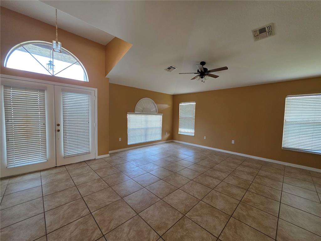 4532 Great Blue Heron Drive Lakeland, FL 33812 - Photo 6 of 33 wooden floor in an empty room with a window