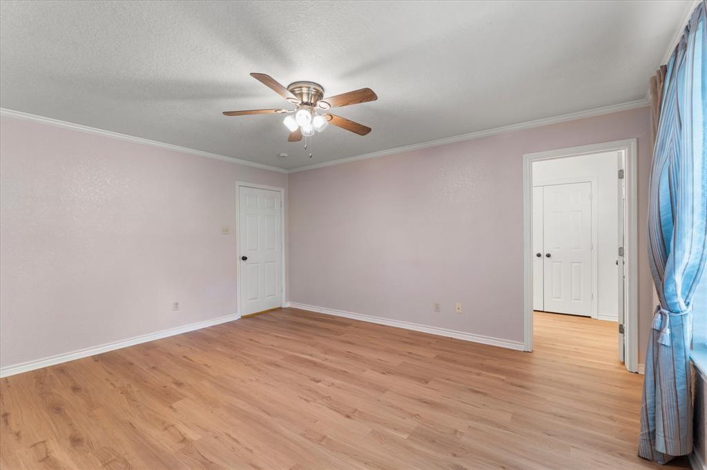 116 Meadowood Road Enchanted Oaks, TX 75156 - Photo 23 of 37 Spacious room with wood-finish flooring, ceiling fan with integrated lighting, and white trim molding